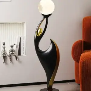 gold and black woman dancing lamp